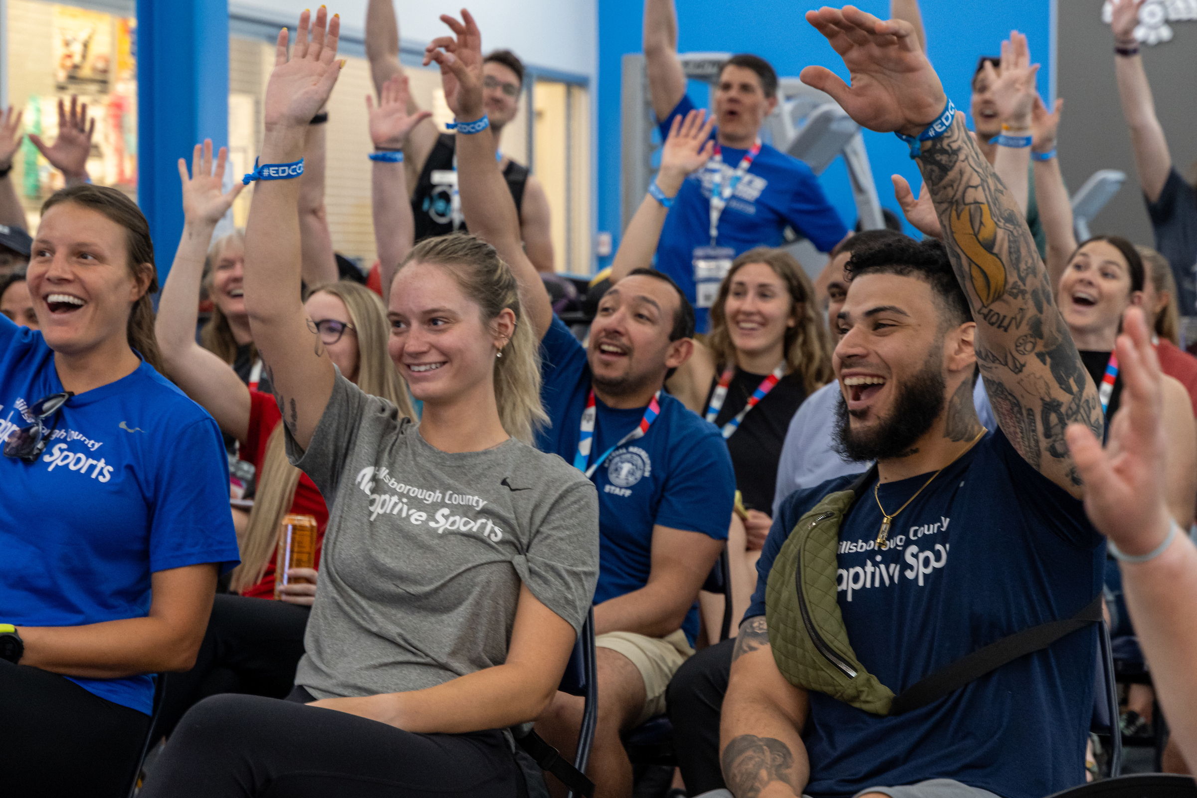 People raising their hands at a conference workshop