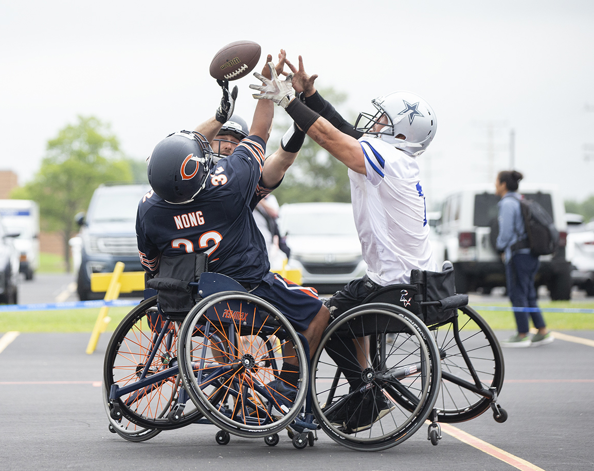 Three players go up for a football during a game