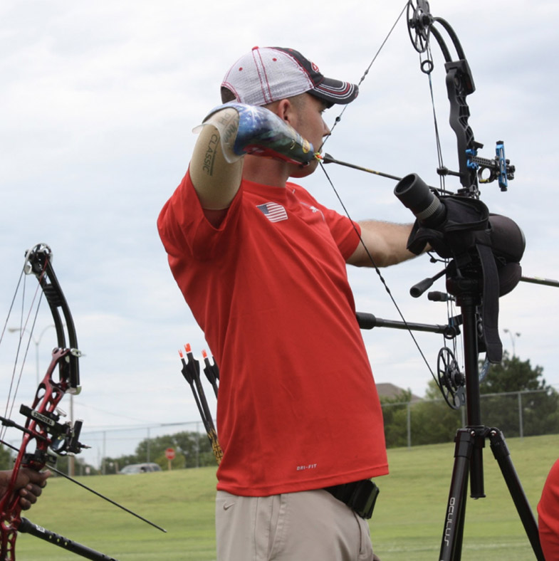 Athlete with right arm amputation aiming crossbow
